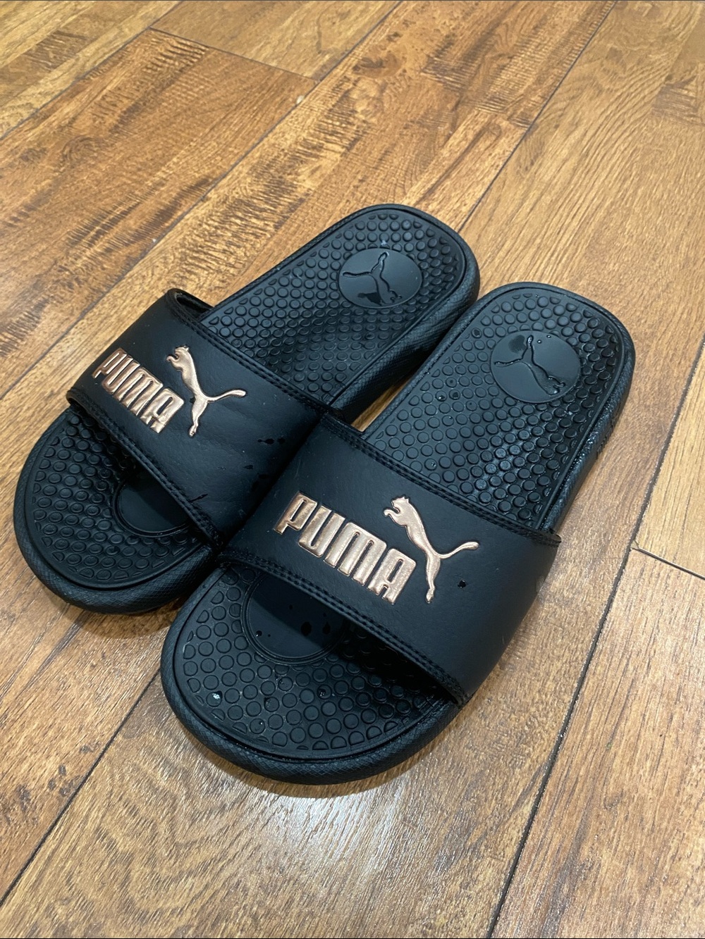 Puma Black Slides with Rose Gold Logo Accent